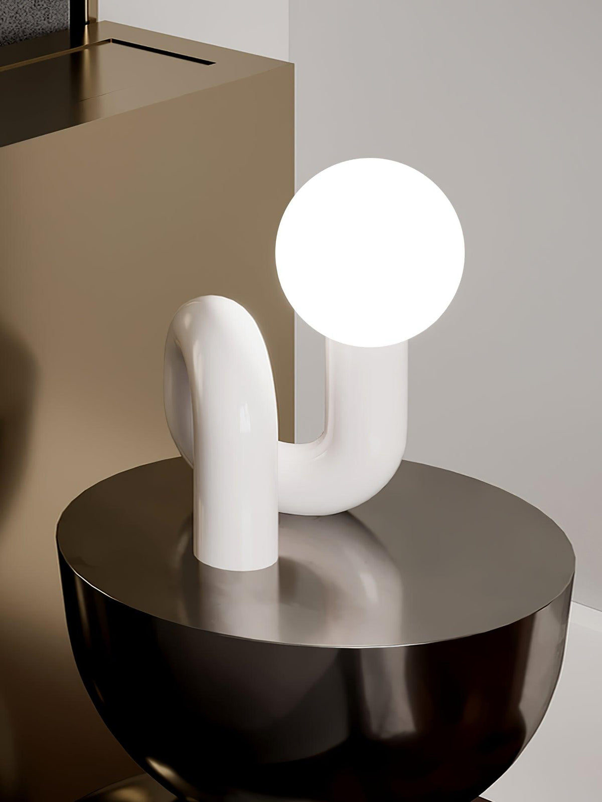 White Playful N Shape Table Lamp displayed on a sculptural side table